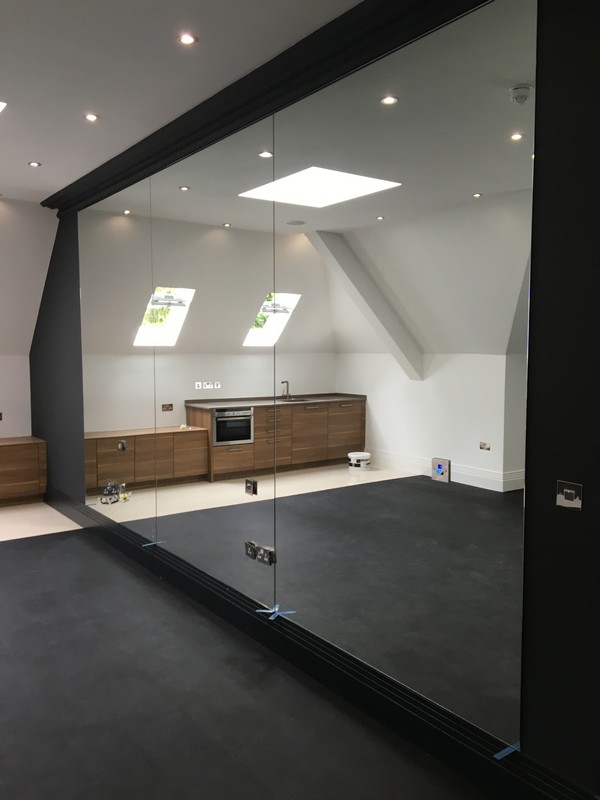 Frameless glass partition in loft conversion by Friern Barnet glaziers